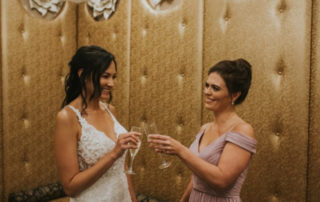 Bride and Maid of honor toasting in The Grandview's Wedding Suite