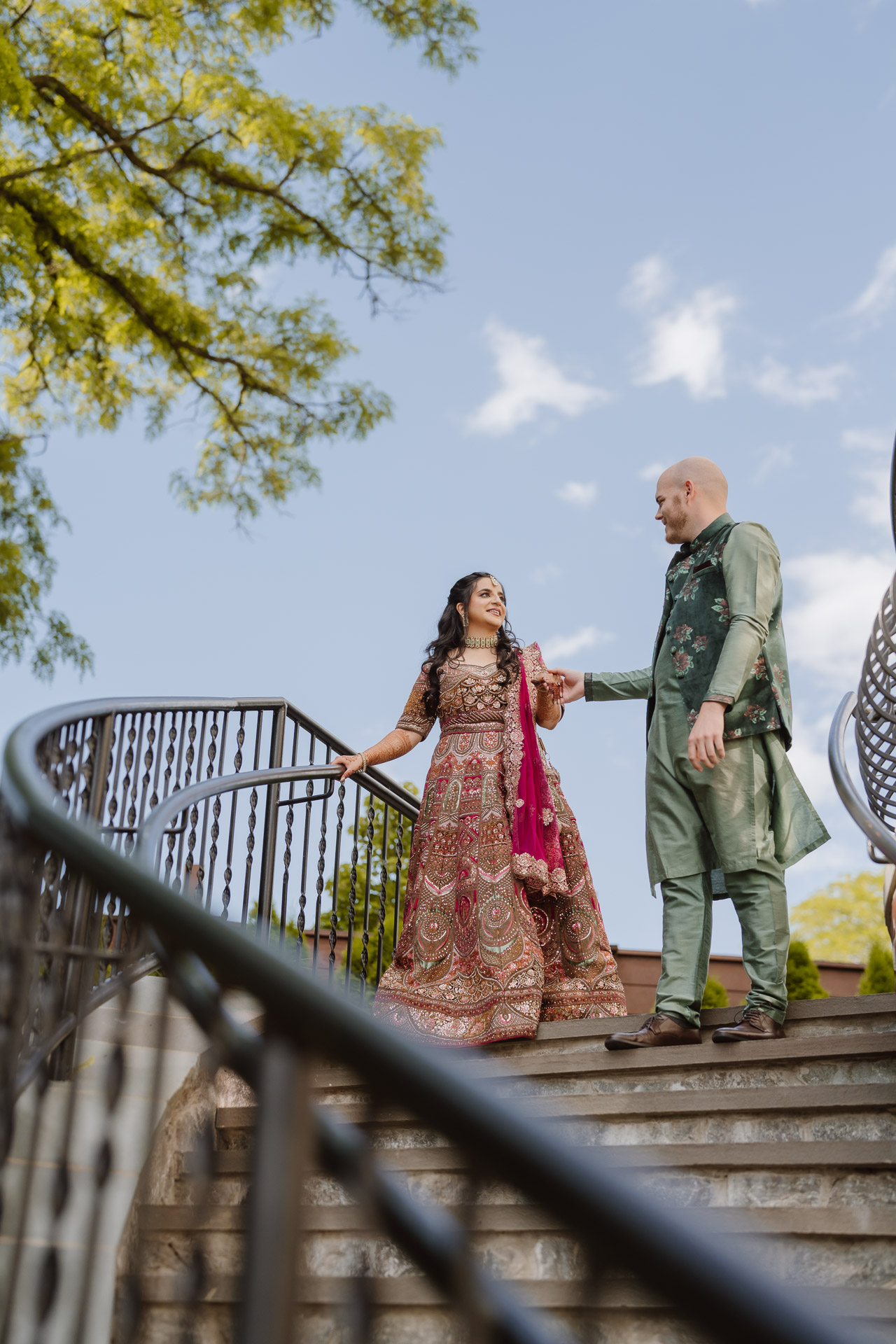 South Asian couple walking down the wedding cottage stairs at The Grandview in Poughkeepsie